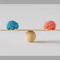 An image of two brains on a scale to represent cognitive biases.